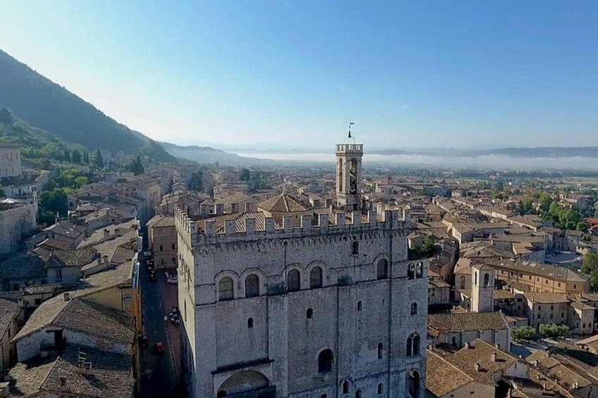 A historic town with a prominent tower and fortress-like buildings. 3