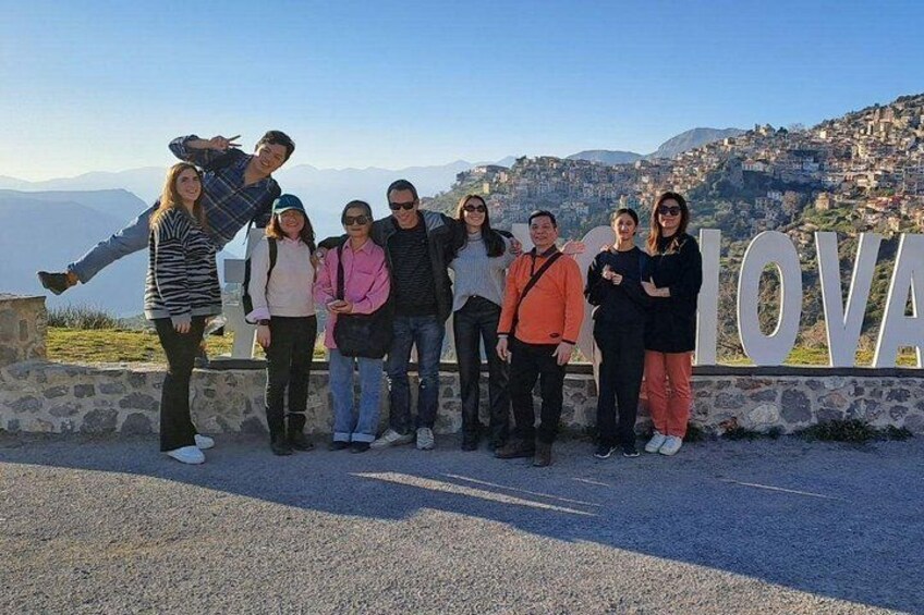 Our tour host with guests, with the town of Arachova in the background 2