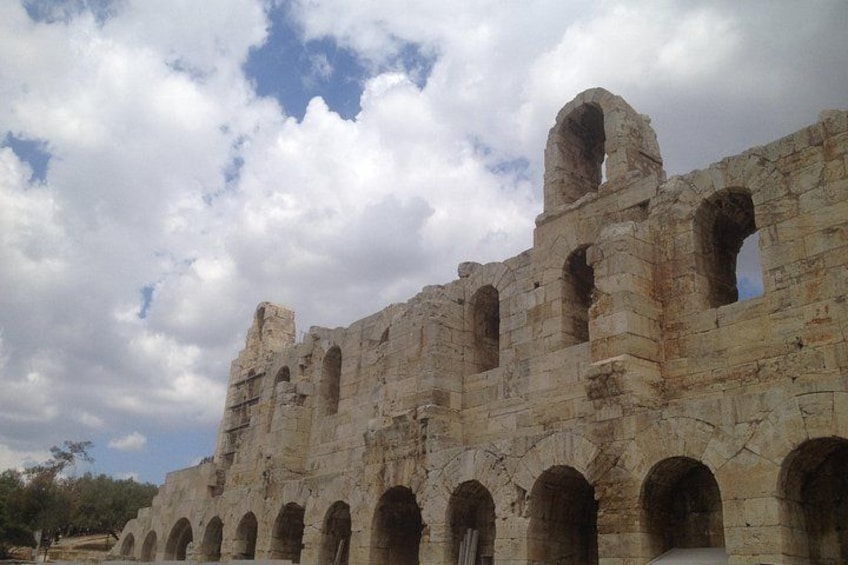 Ancient stone ruins with multiple arches and a partially intact wall. 4