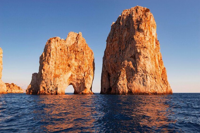 A coastal rock formation with a natural arch. 2