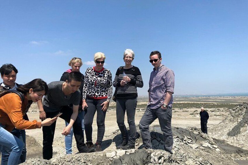 A group of people on a rocky terrain with a clear sky. 5
