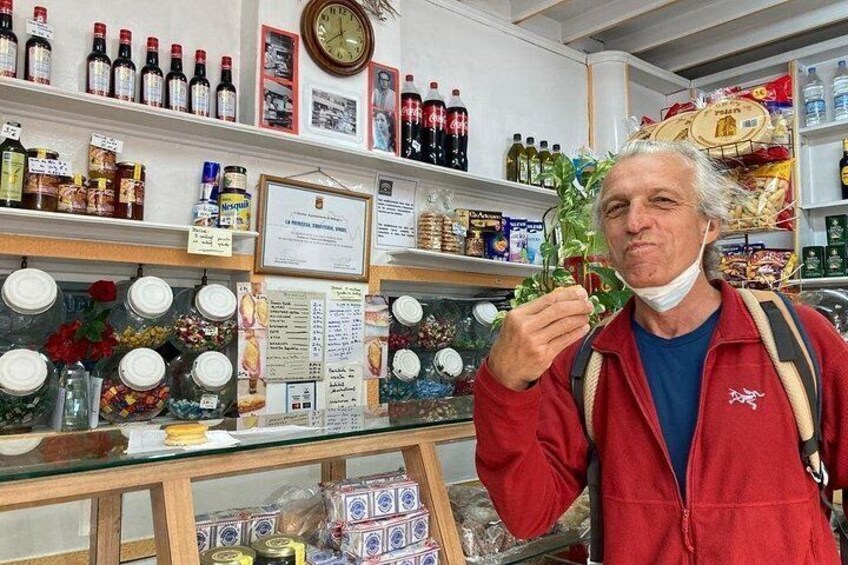 A person holding a plant in a store with shelves of various products. 2