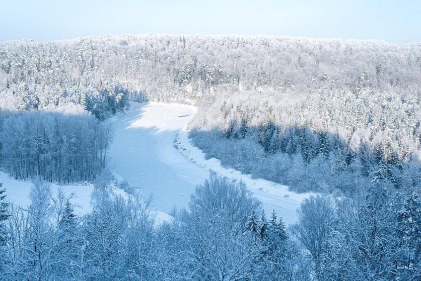 A snow-covered forest with a frozen river. 4