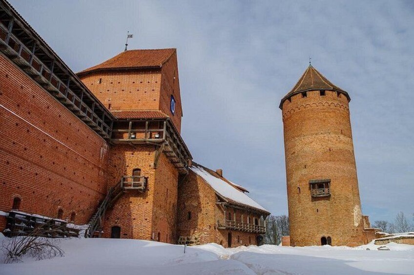 A brick building with a tower and a staircase. 2