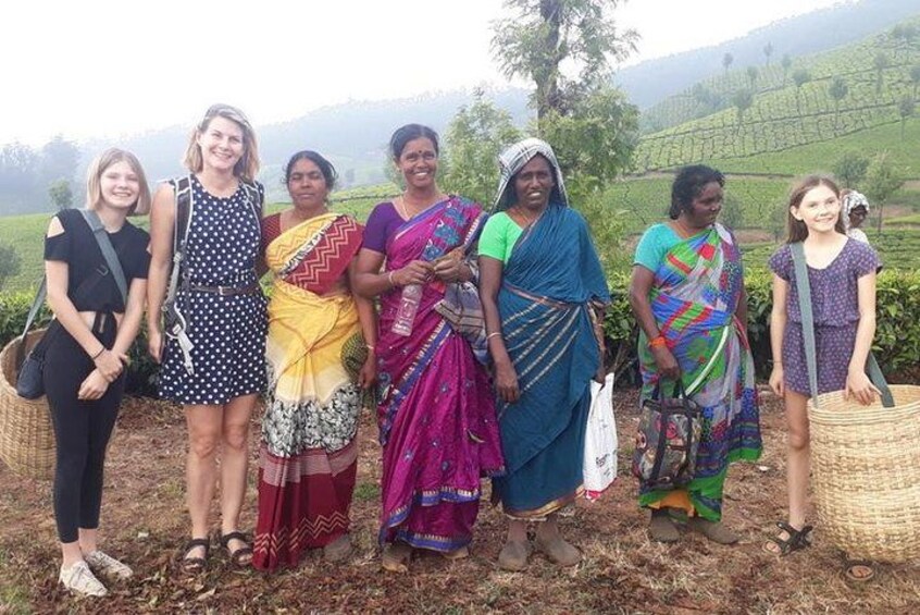 A group of people standing outdoors with a hilly landscape in the background. 2