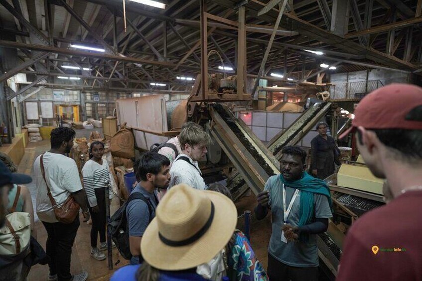 A group of people in an industrial setting with machinery and materials. 4