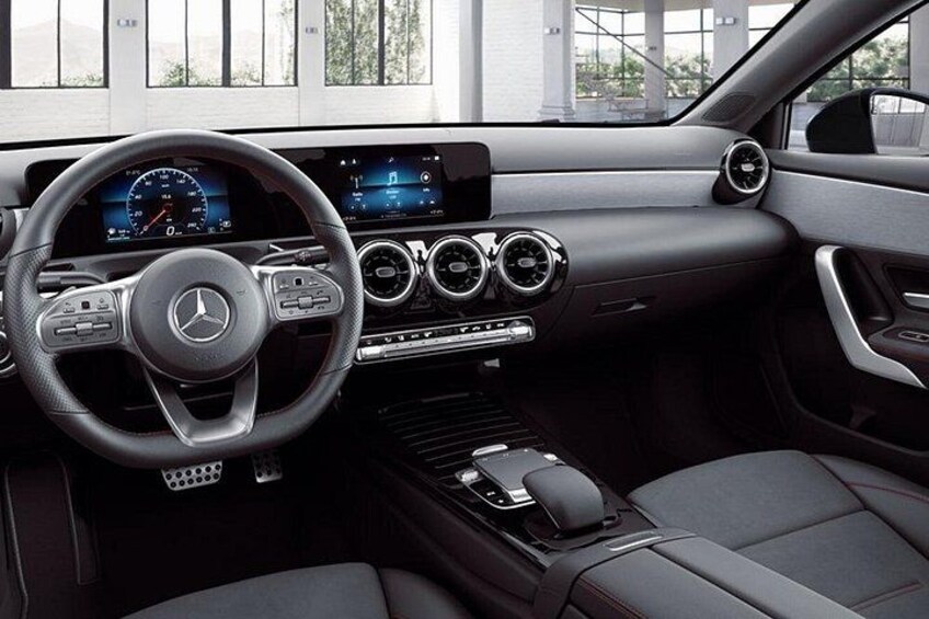 A luxury car interior with a digital dashboard, leather seats, and a manual gear shift. 3