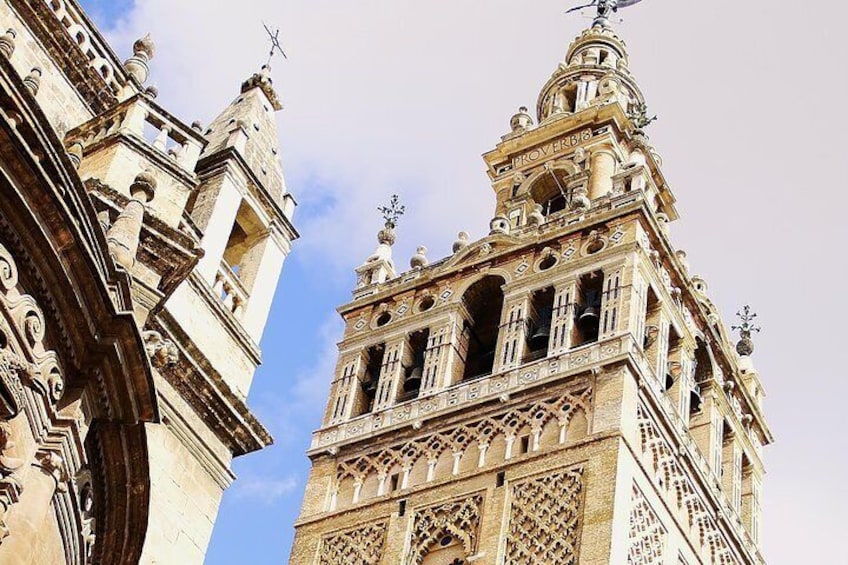 A historic building with ornate architecture, including a bell tower and intricate stone carvings. 1