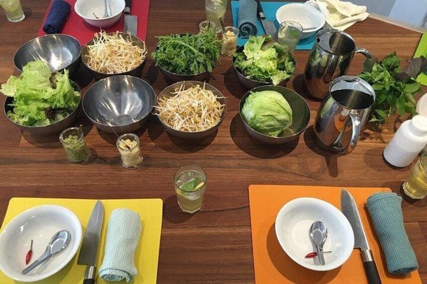 Una mesa con diferentes recipientes de comida, utensilios y salsas. 4