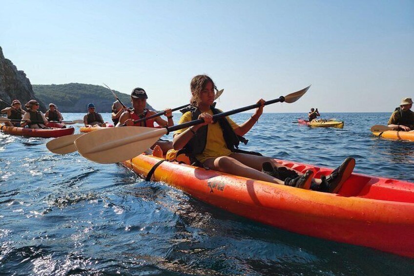 Budva Kayak & SUP Rental – tandem kayakers paddling near a rocky coast in Budva Bay, Montenegro 5