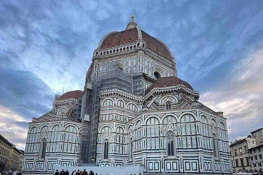 The Florence Cathedral with its distinctive white and green facade, large dome, and intricate architectural details. 5