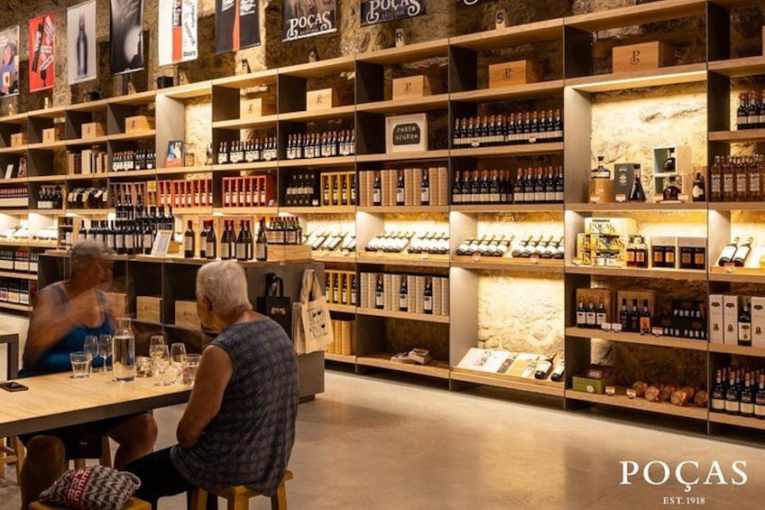 A wine store with shelves of bottles and boxes. 5