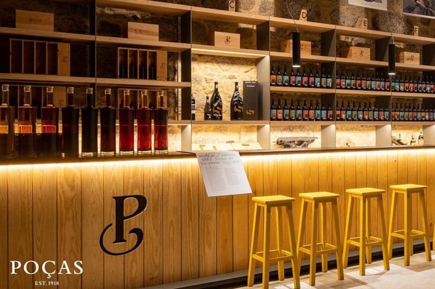 A bar with wooden shelves and stools. 4