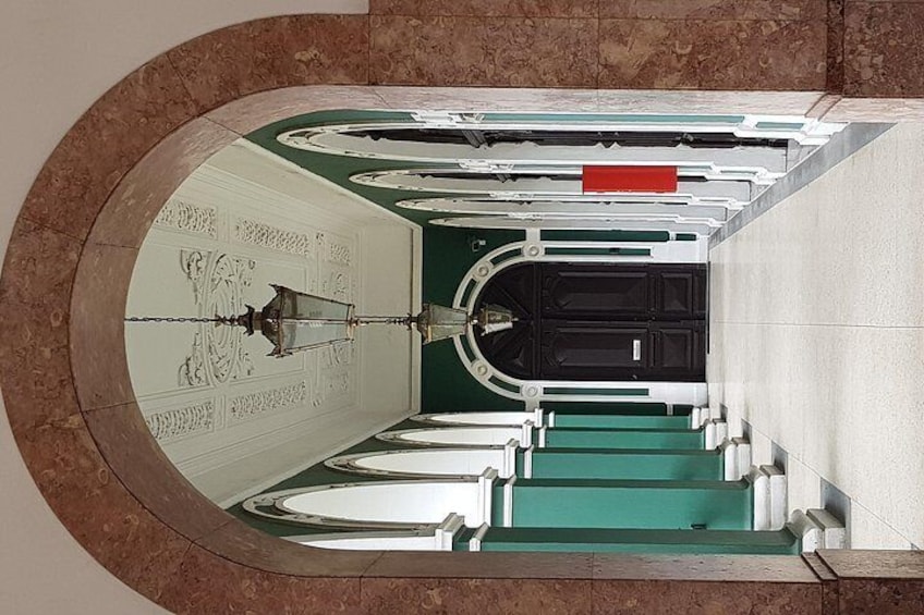 A circular architectural structure with a central staircase and a reflective ceiling. 4