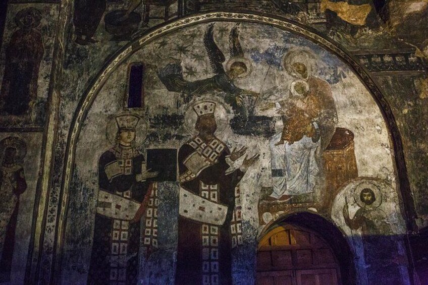A mosaic with religious figures, an arched doorway, and architectural details. 5