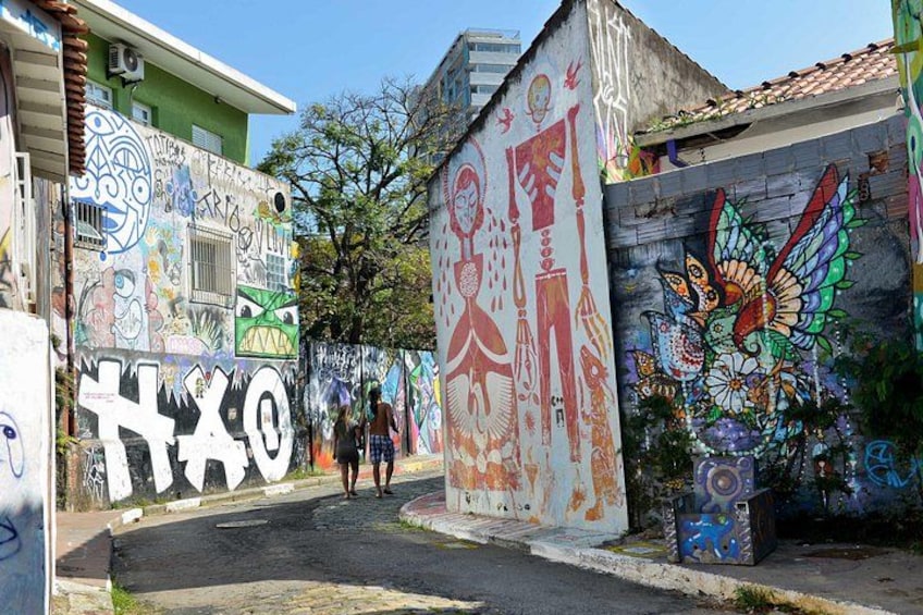 A street with colorful graffiti on buildings and walls. 2