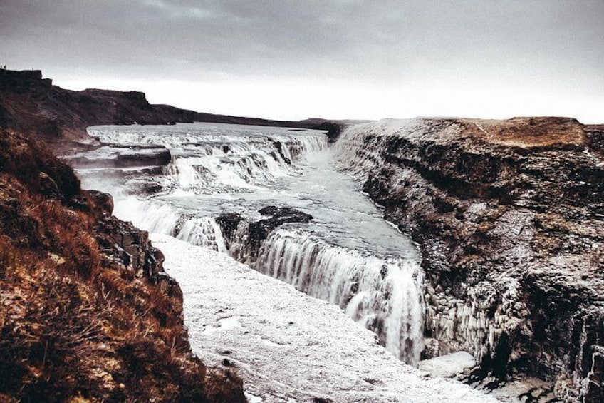 A waterfall cascading over a rocky cliff. 4
