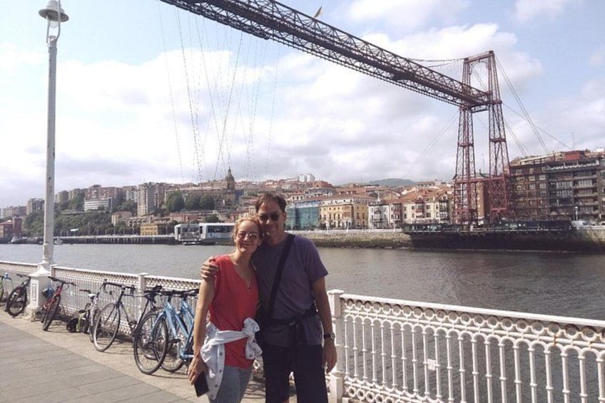 A bridge, a river, and a cityscape with buildings in the background. 2