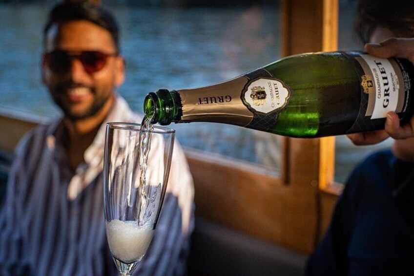 A person pouring champagne into a glass. 1