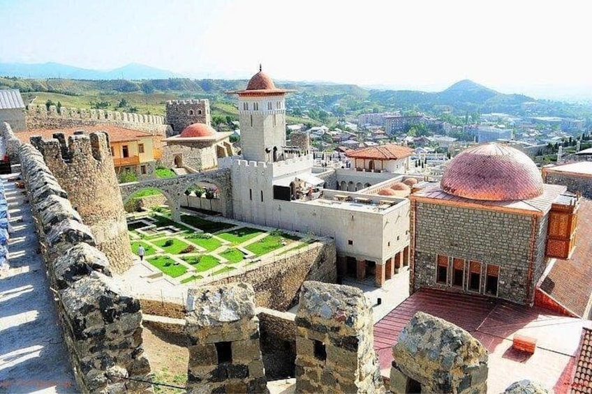 A historic fortress with a central courtyard, a watchtower, and a dome-shaped building. 2