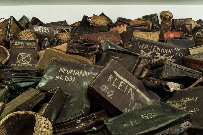 A collection of old, worn leather-bound books with visible text and inscriptions. 4