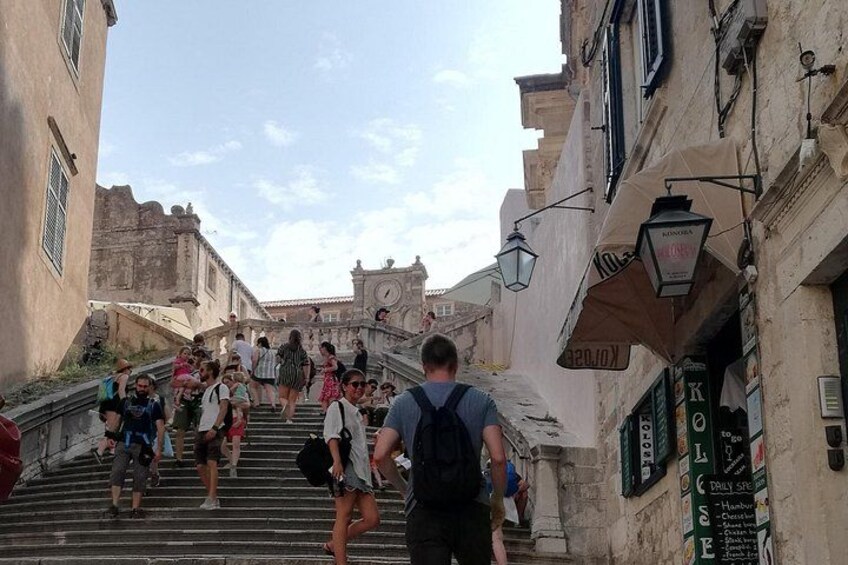 A group of people ascending a stone staircase in a historic town. 2