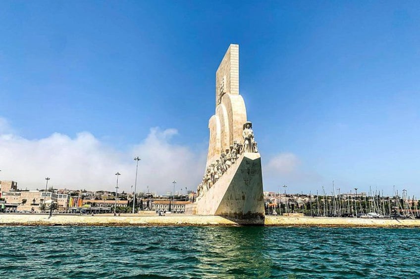 A large monument by the sea with a clear sky. 3