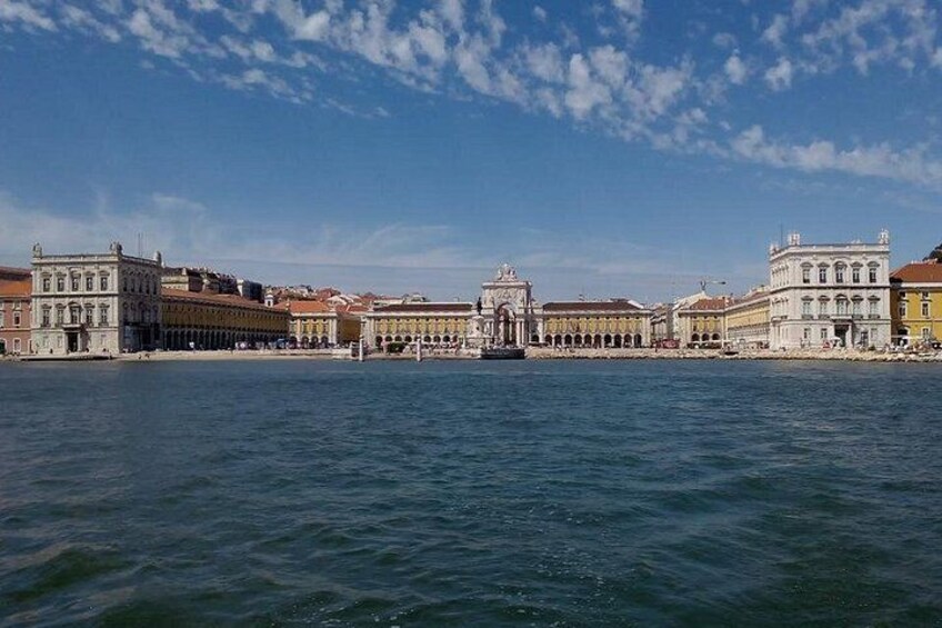 A waterfront with historic buildings and a central plaza. 4