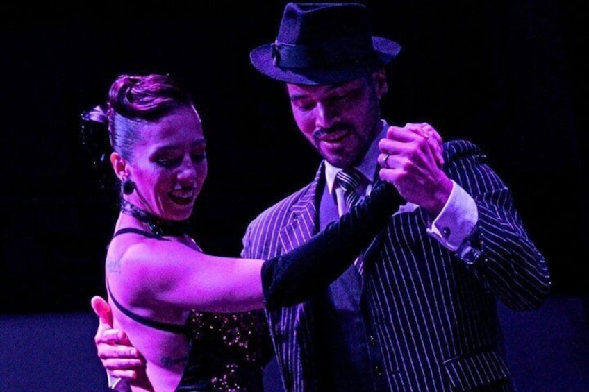 A couple dancing, a man in a pinstripe suit and a woman in a dress. 2