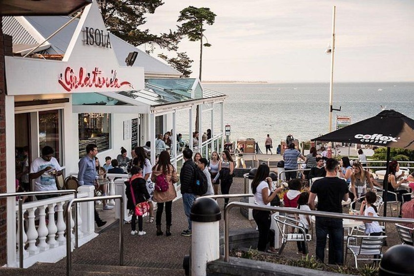 A coastal café with outdoor seating overlooking the sea. 4