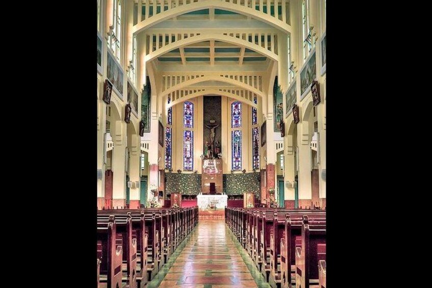 A church interior with pews, stained glass windows, and a central altar. 2