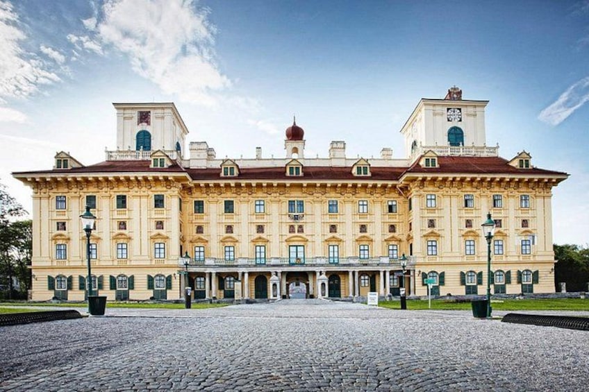 A large, historic building with a symmetrical facade, multiple windows, and a central entrance. 1