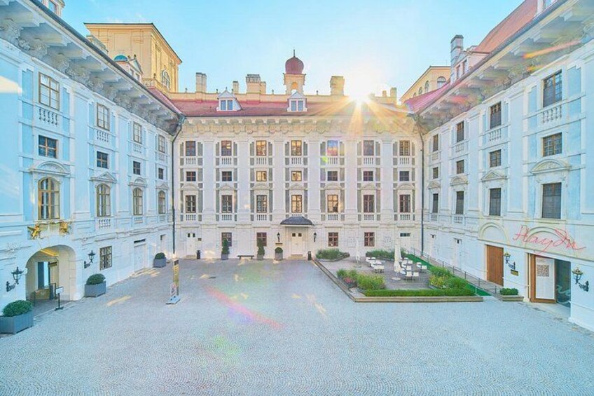 A large, ornate building with a central courtyard, surrounded by smaller structures. 2