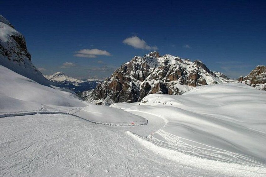 A snow-covered mountain landscape with a ski trail. 1