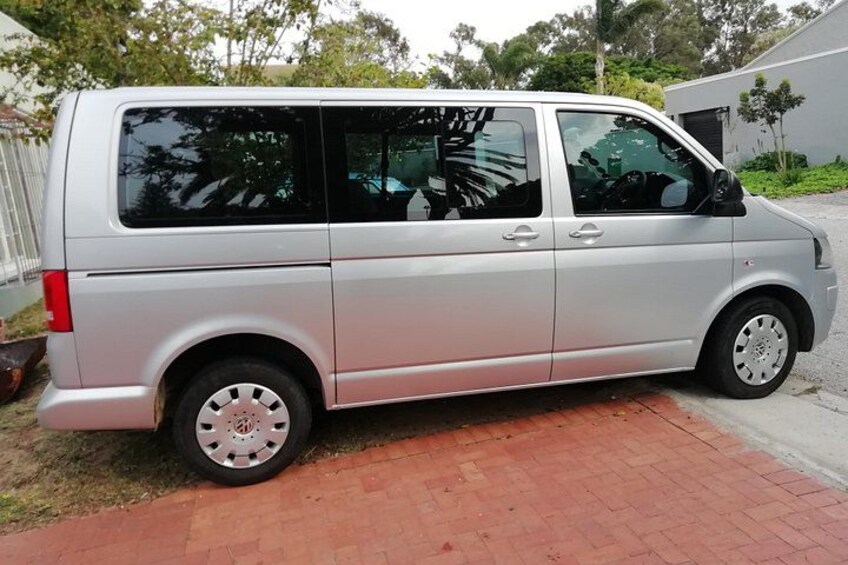 A silver van parked on a brick driveway. 5