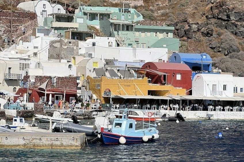 A coastal town with colorful buildings, a harbor with boats, and a rocky hillside in the background. 4
