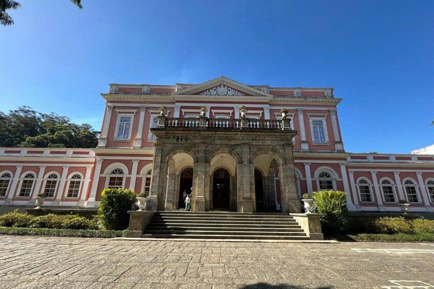 A large, historic building with a grand entrance, arched doorways, and a symmetrical facade. 2