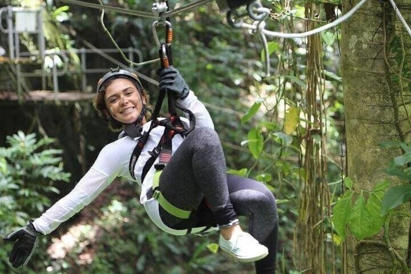 A person zip-lining through a forested area. 5