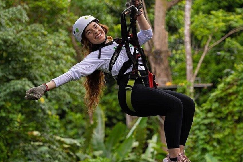 A person zip-lining through a forest. 1