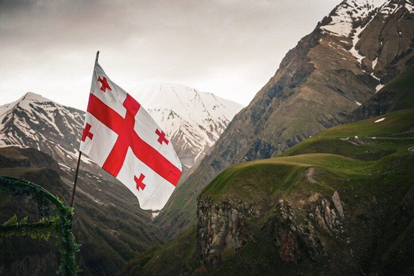 A mountainous landscape with a flag. 2