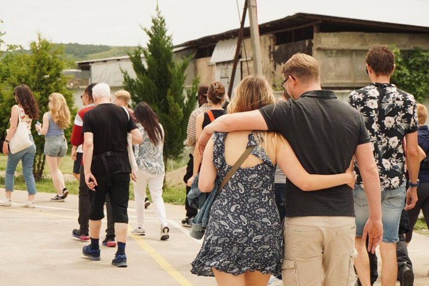 A group of people walking on a paved path. 4