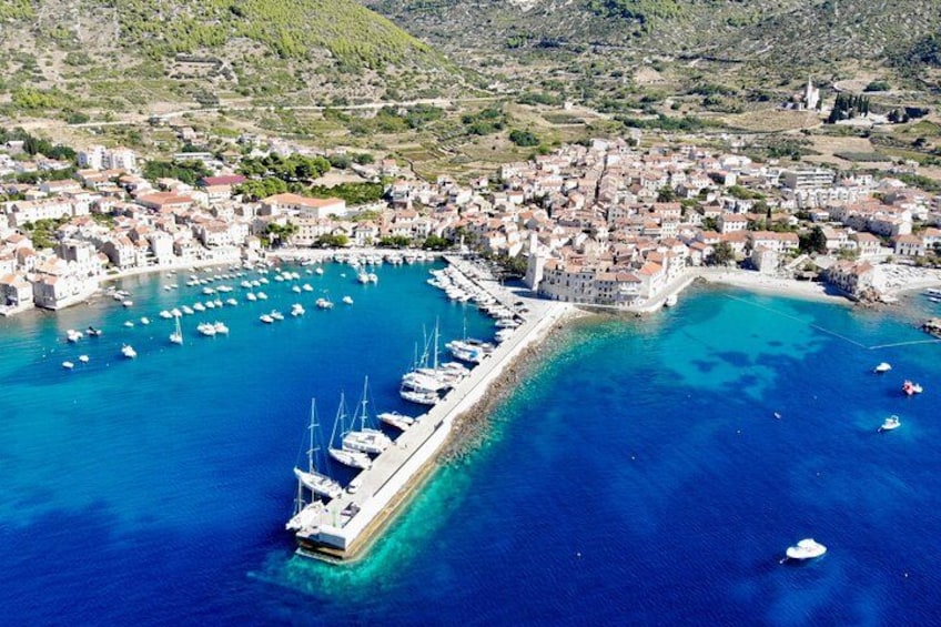 A coastal town with a marina, boats, and buildings. 5