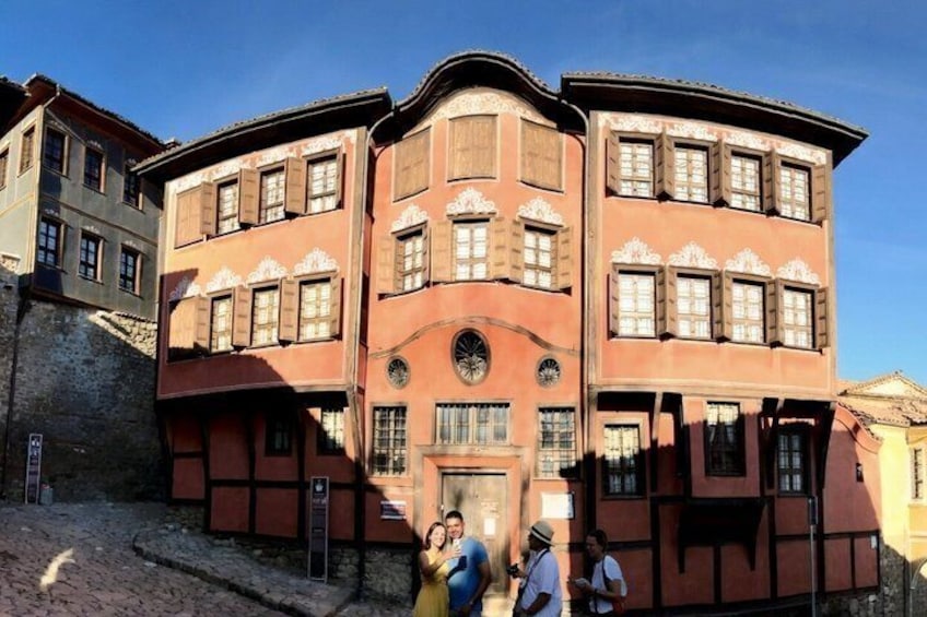 A multi-story building with a curved facade, large windows, and a central arched entrance. 5