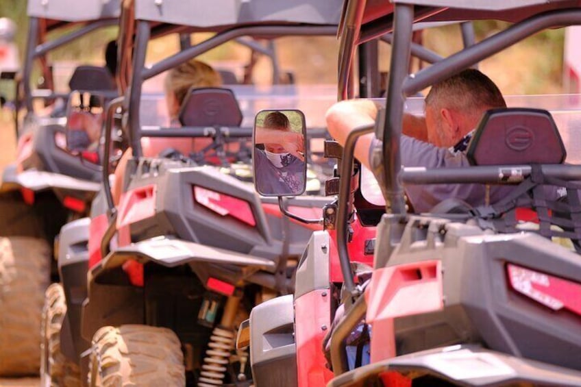 A row of red all-terrain vehicles (ATVs) parked in a line. 4