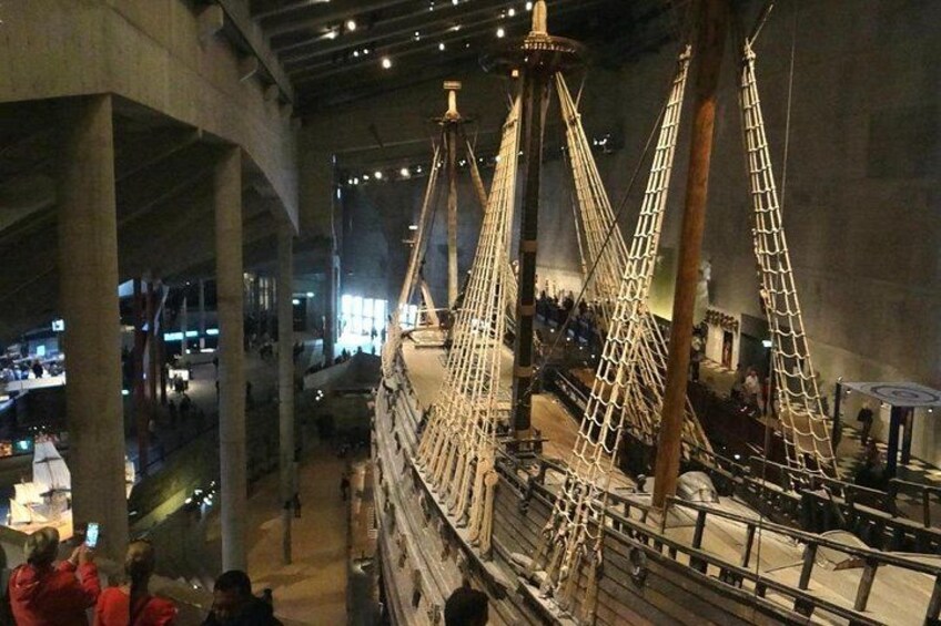 A large ship model inside a building with visible masts and rigging. 5