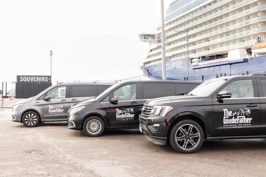 Three black vans with 'The GuideFather' logo parked in front of a cruise ship. 1