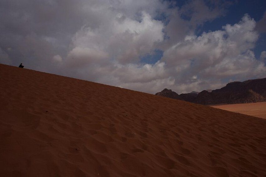 A desert landscape with sand dunes and a clear sky. 5