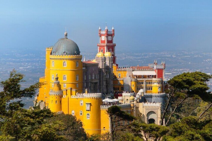 Pena Palace with its distinctive yellow and red architecture, including the Torre dos Descobrimentos. 2