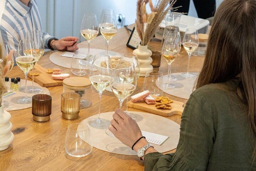 A dining table with multiple wine glasses, plates, and cutlery. 4