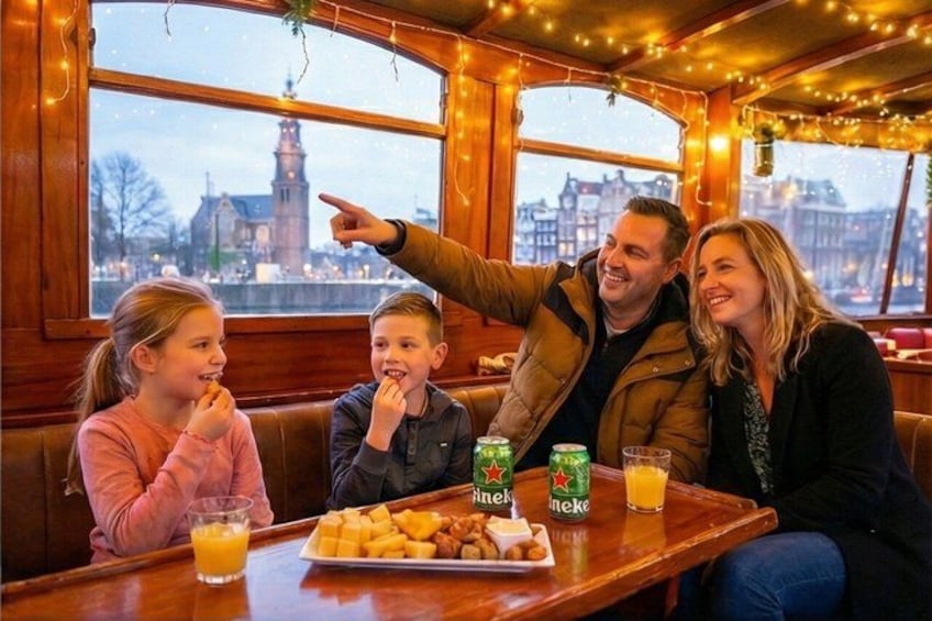 A family dining at a restaurant with a view of a clock tower. 3